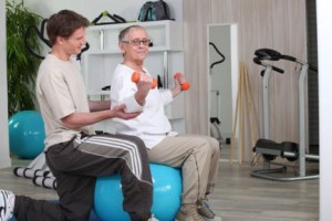 2445799-older-woman-working-out-with-a-personal-trainer-at-the-gym